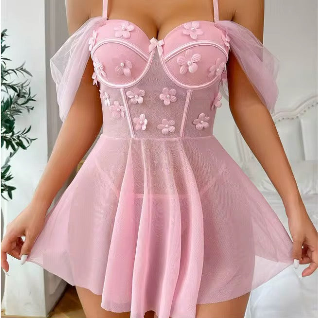 Pink lace dress with floral details on a neutral background