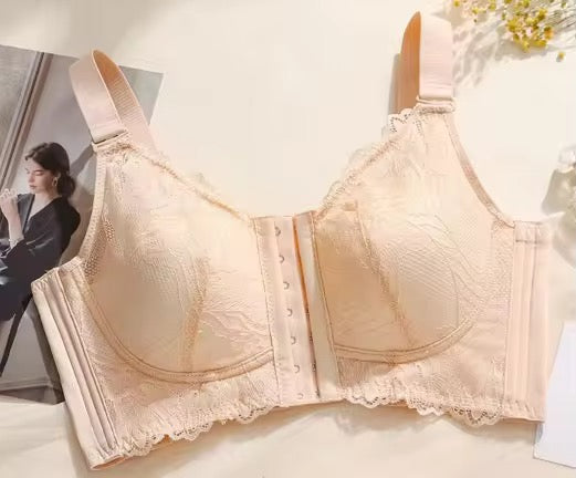 Beige bra on a white background with a blurred person in the background.