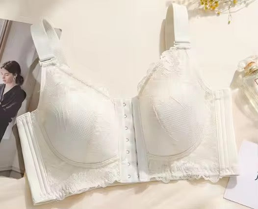 White bra displayed on a white background with a blurred woman in the background.