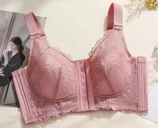 Pink bra with lace details on a light background