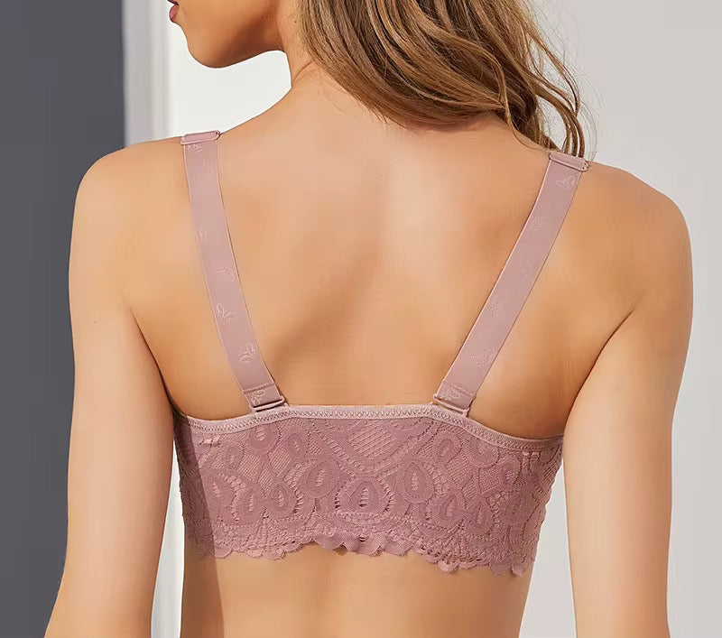 Pink lace bra worn by a model against a neutral background