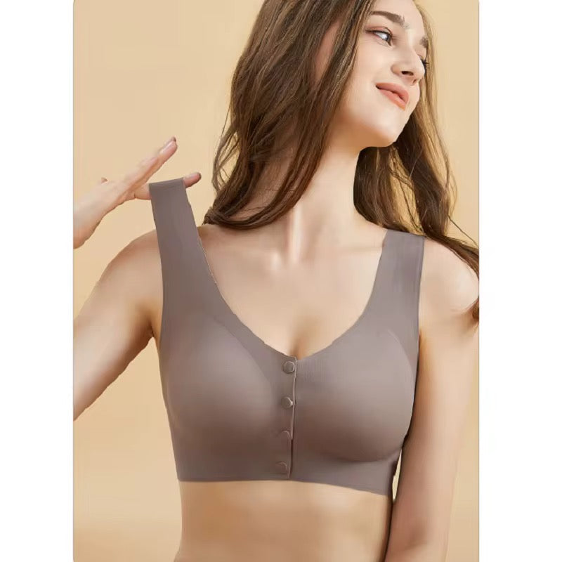 Woman wearing a gray bralette against a beige background