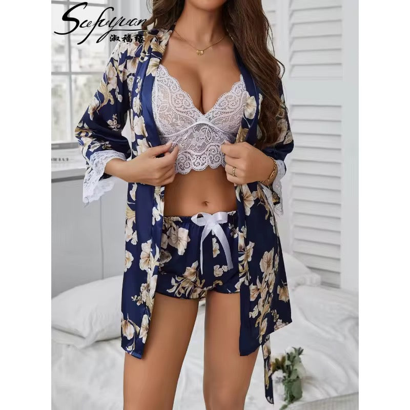 Woman wearing a floral robe over a white lace bra and shorts set in a bedroom setting.