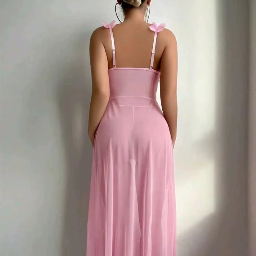 Pink dress with thin straps and floral details on a plain background