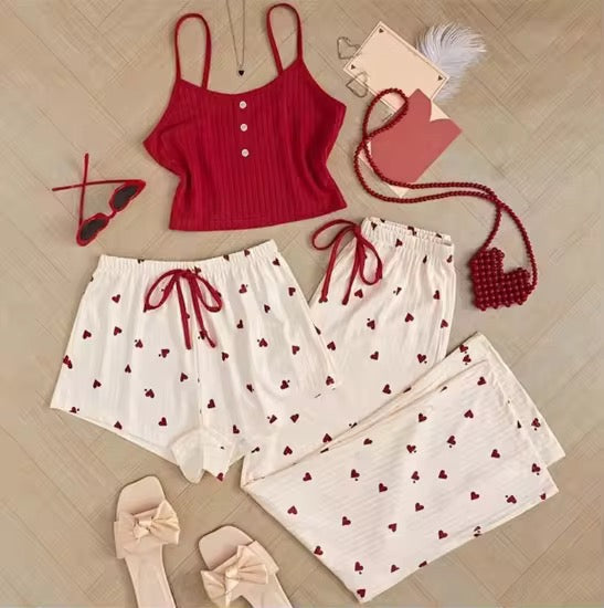 Red top and white shorts with red heart patterns on a wooden floor.