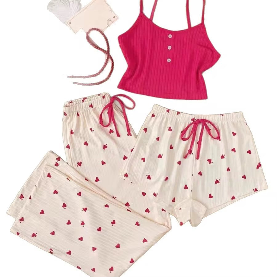 Pink tank top and cream shorts with red heart patterns on a white background