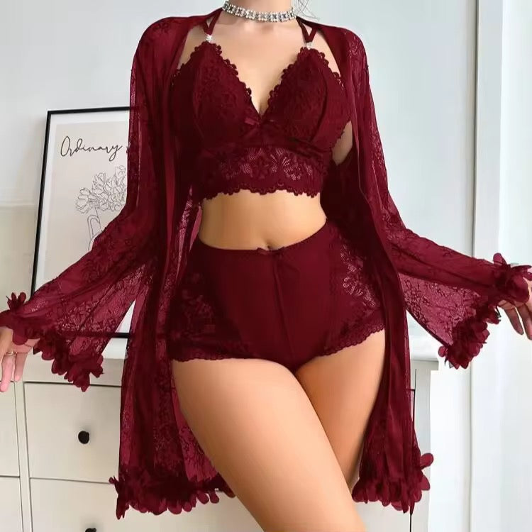 Burgundy lace lingerie set with matching robe on a neutral background