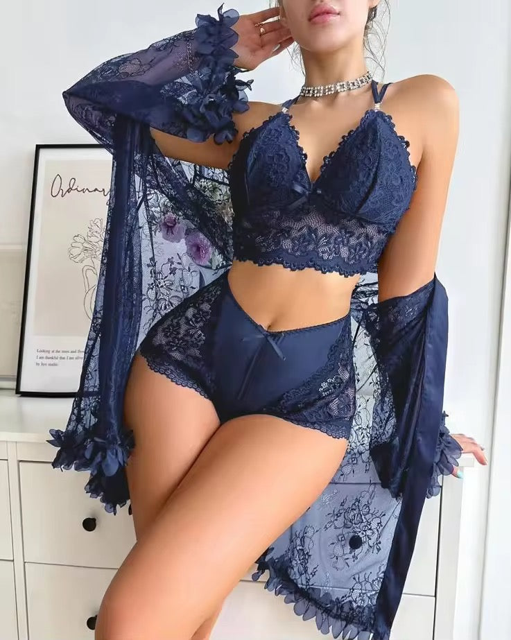 Woman wearing a navy blue lace lingerie set with a matching robe.