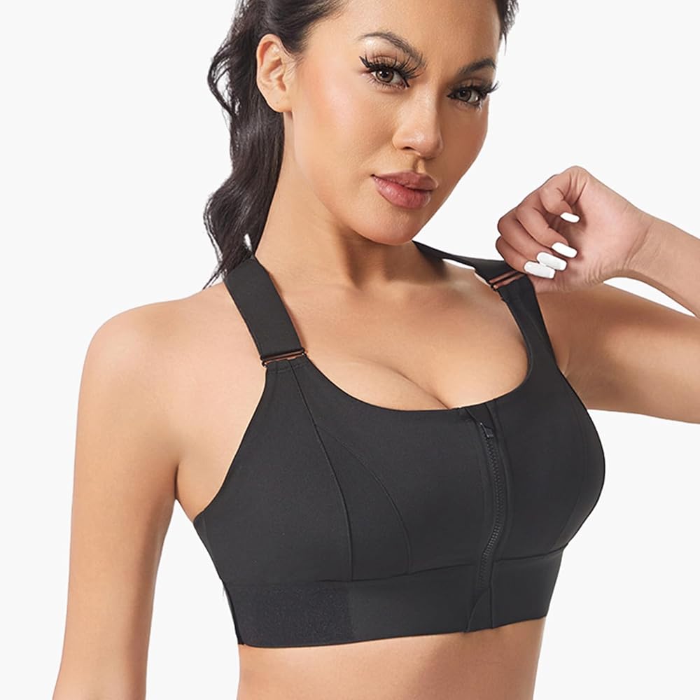 A woman wearing a black wireless sports bra with a front zipper and adjustable shoulder straps, shown against a plain light background.