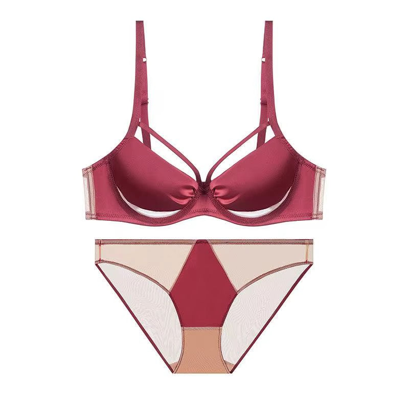 A two-piece lingerie set featuring a satin-like burgundy underwire bra with sheer mesh side panels and matching low-rise briefs with a geometric color-blocked design in burgundy, beige, and sheer mesh.